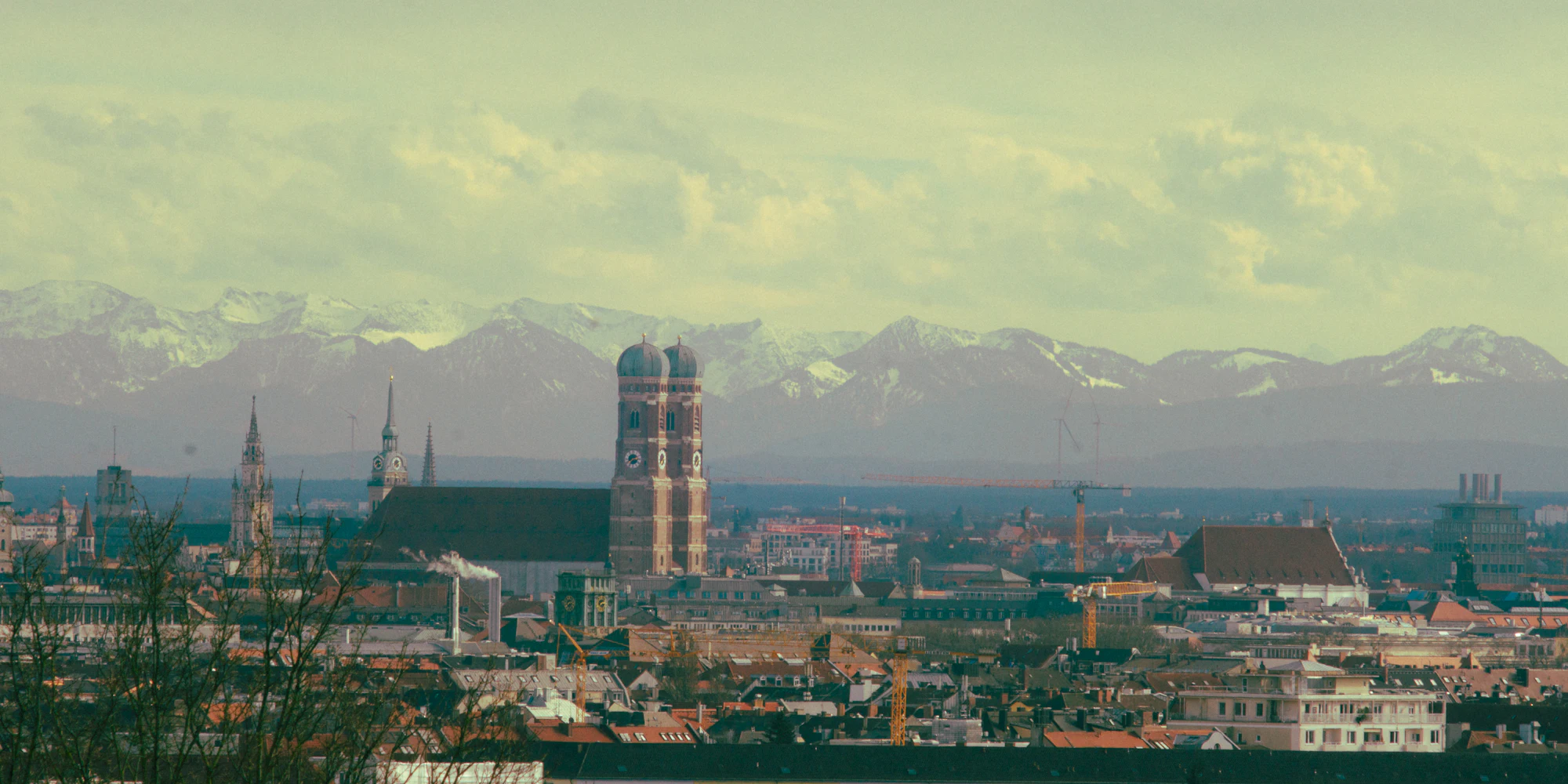 Munich's old town and the Frauenkirche with the Alps behind